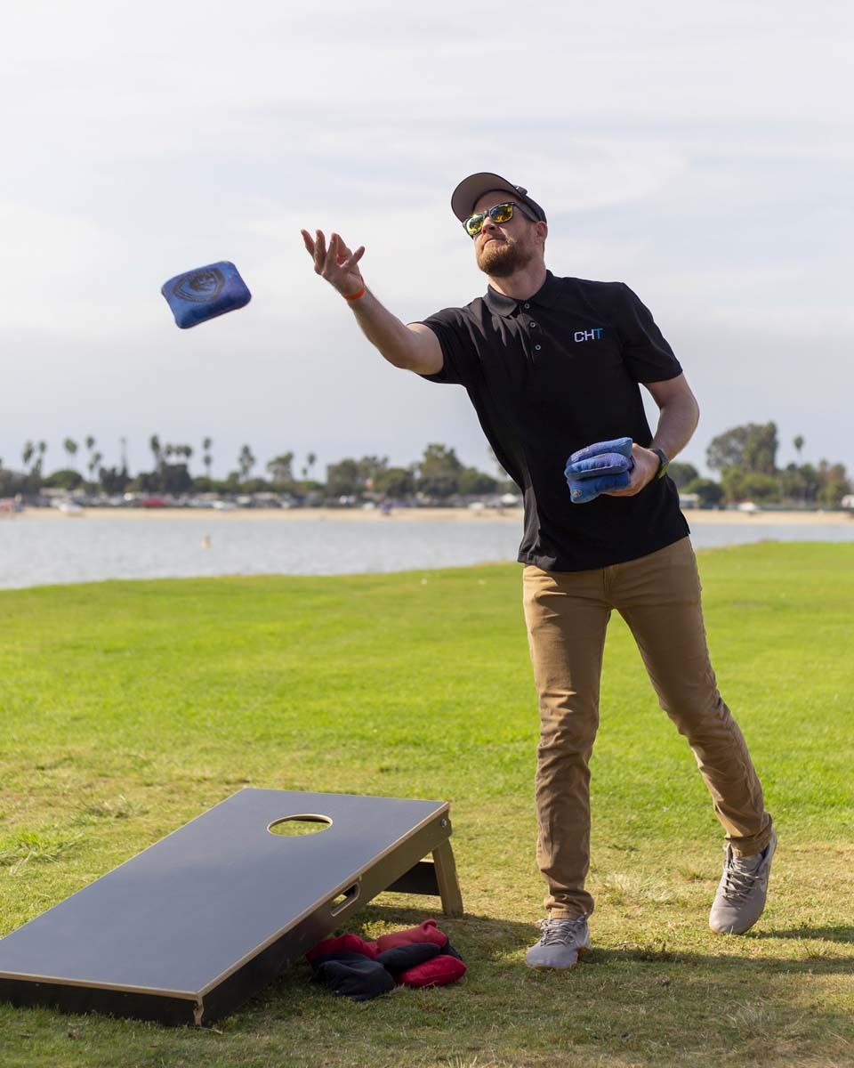 Man throwing bean bag, cornhole