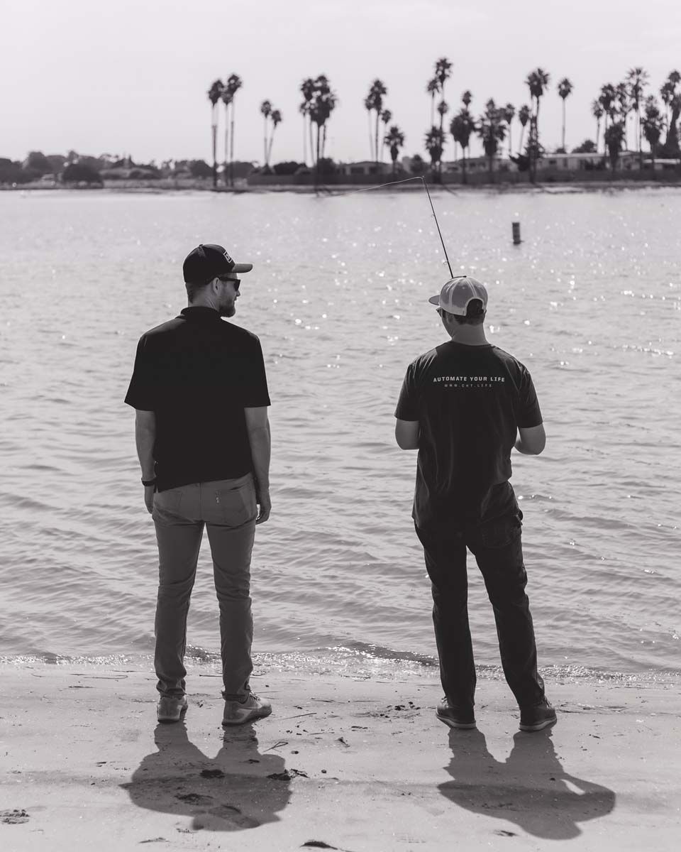 Black and white image, two men fishing