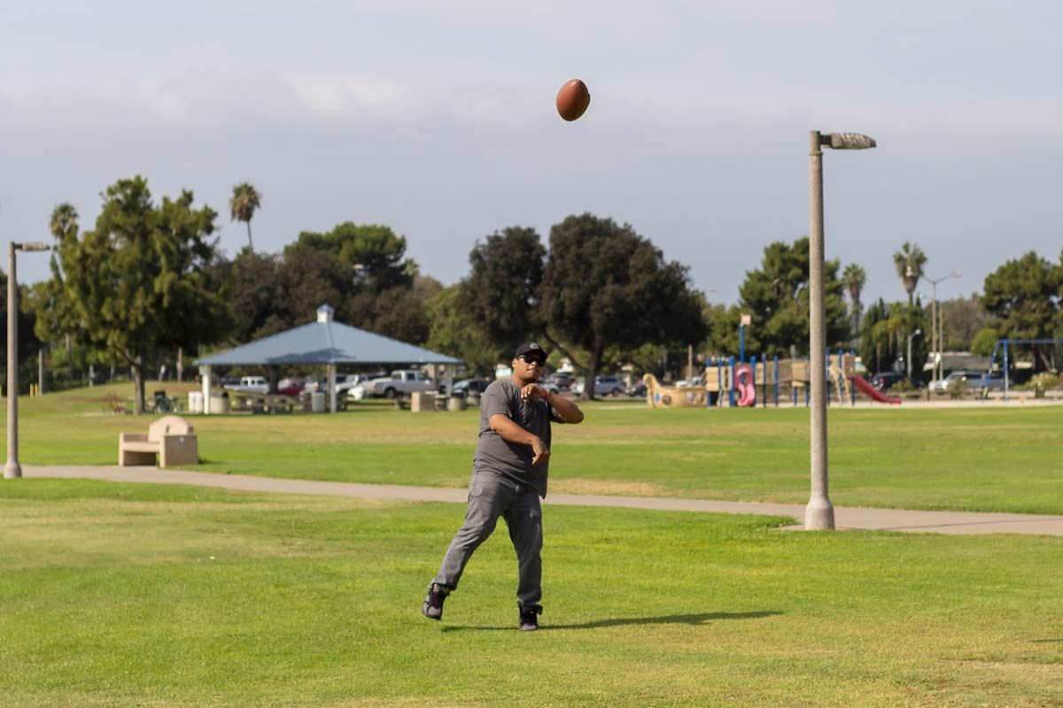 Man in park, playing football