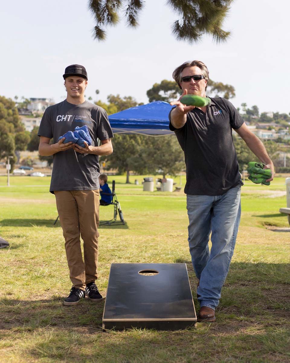 Two men playing cornhole